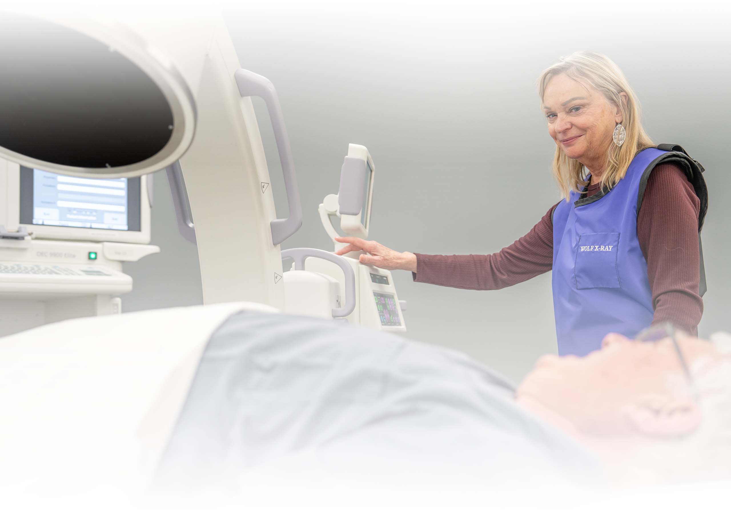A technician helps a patient get ready for a RF scan