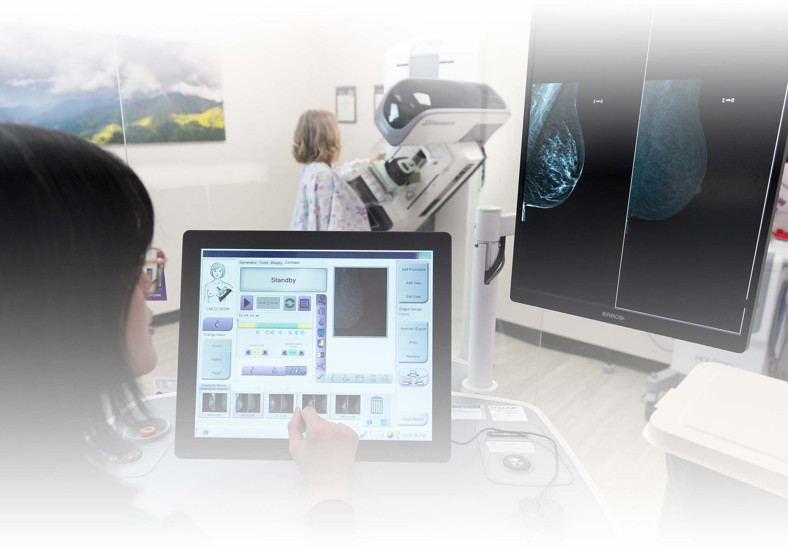 A technician performs a breast imaging scan of a patient