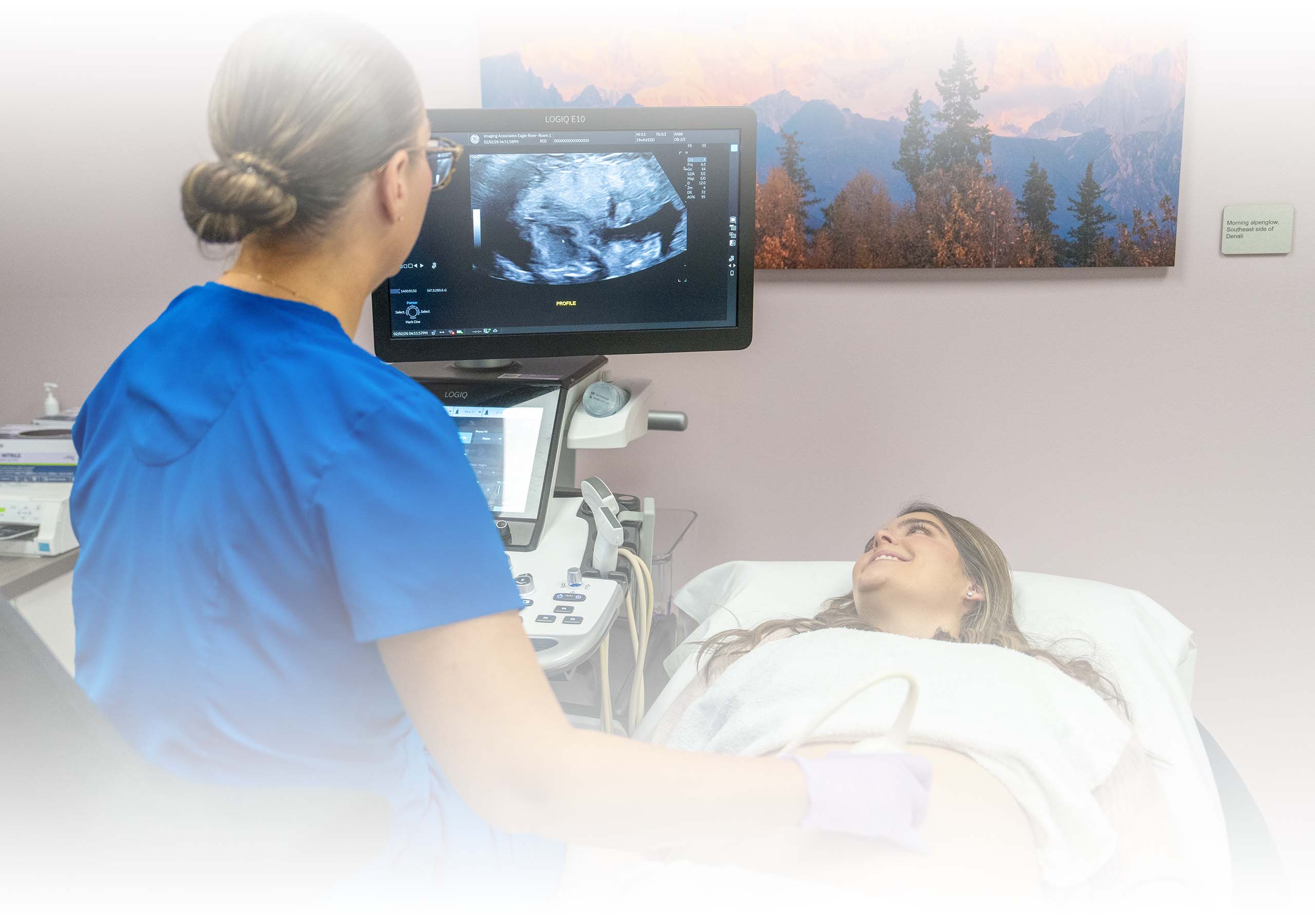 A technician performing an ultrasound on a pregnant mother