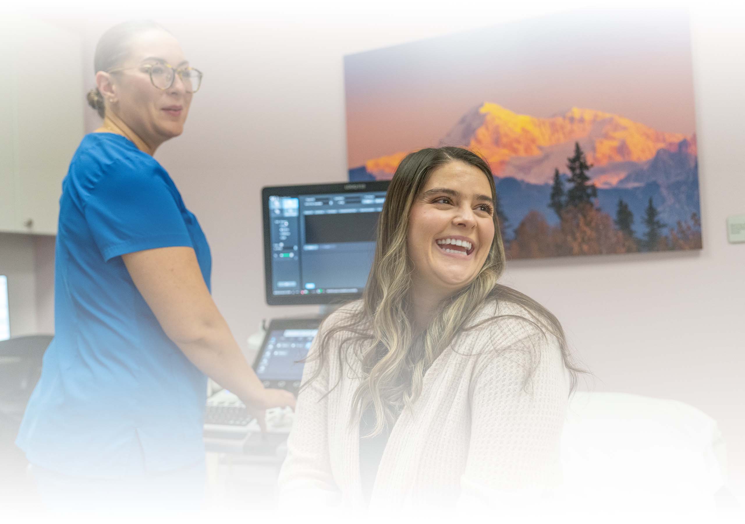 A technician and woman preparing for a breast ultrasound