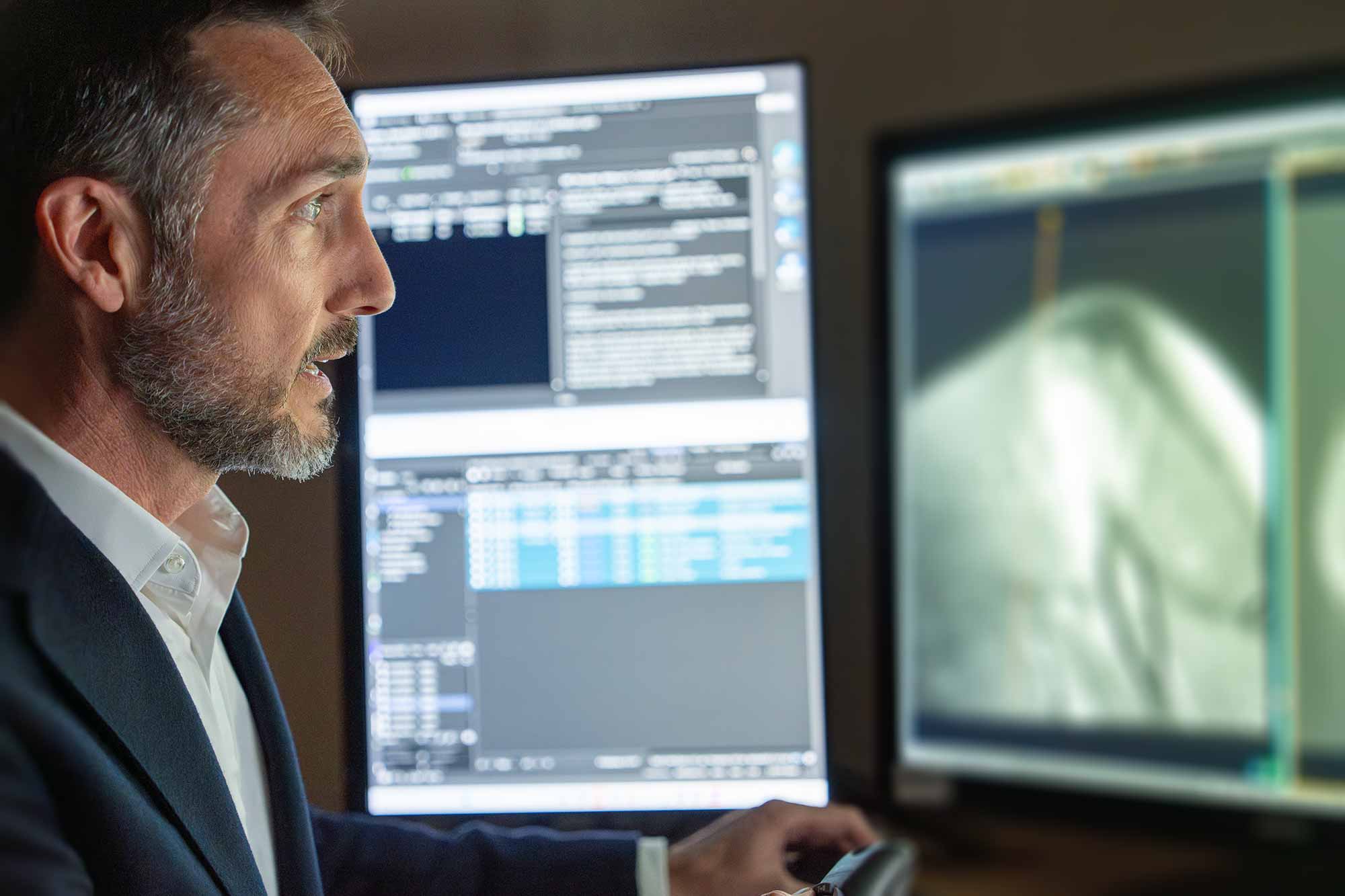 Dr. Reed looking at imaging results on a screen