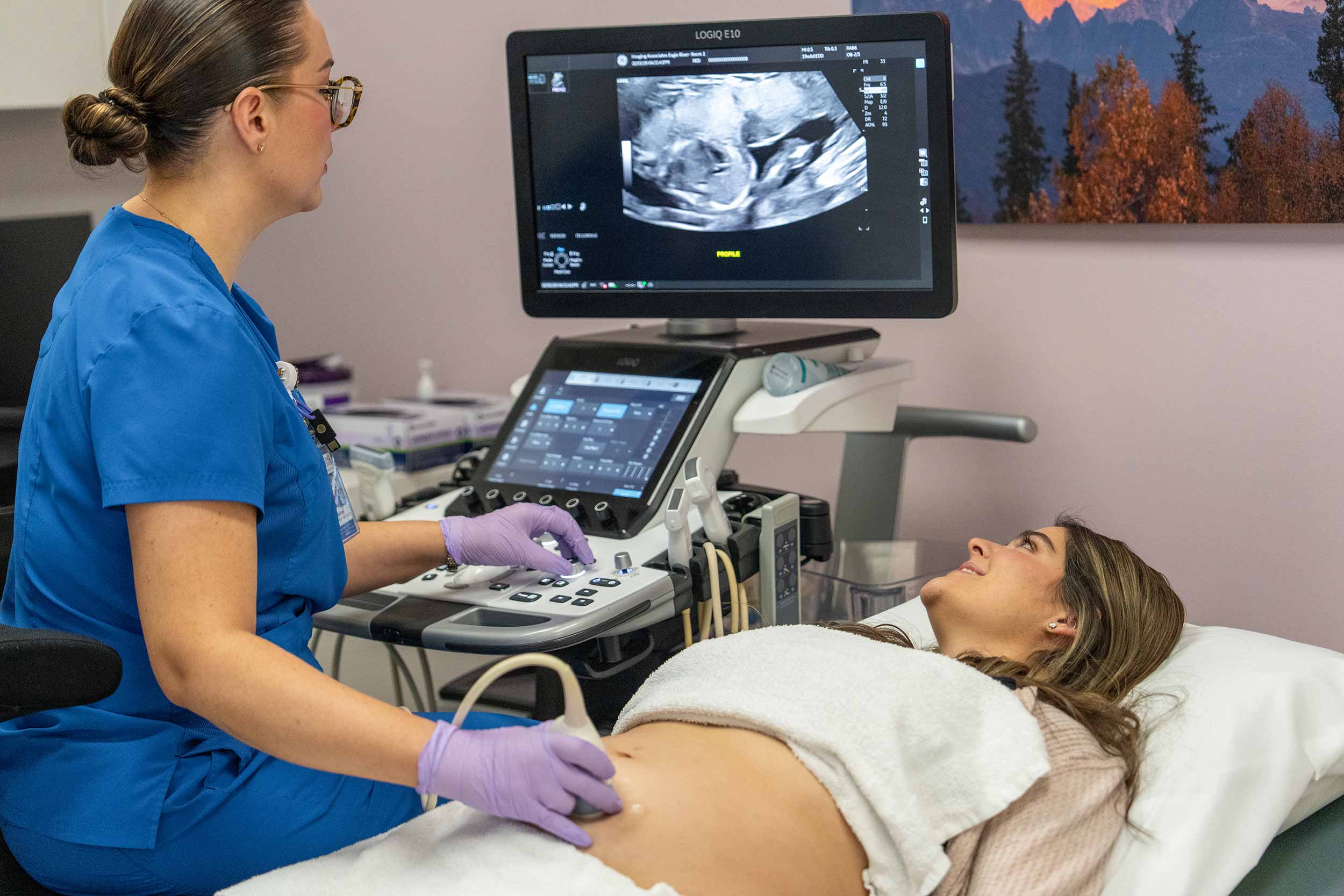 A ultrasound of a pregnant mother being taken by a technician